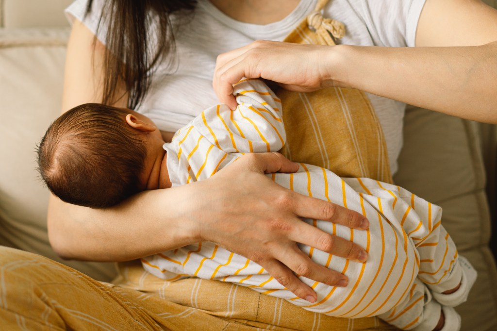 Mother breastfeeding her newborn son